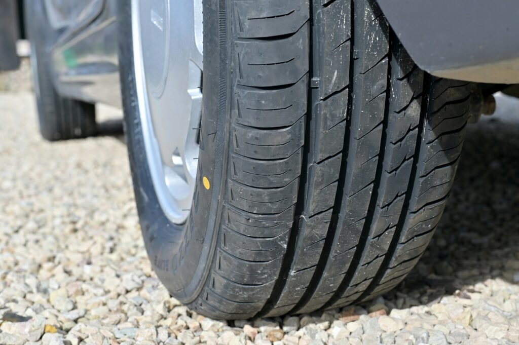 Why Is My Tire Pressure Light Still On After Filling Tires? Expert Diagnosis Guide showing tire pressure testing, TPMS sensors, slow leaks, and dashboard warnings.